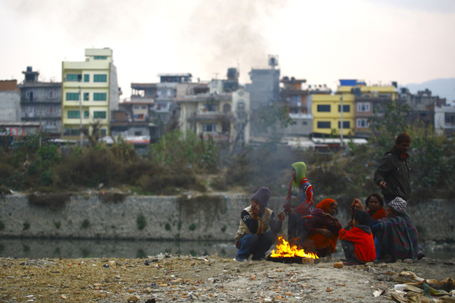 https://archive.nepalitimes.com/assets/uploads/gallery/12250-squatters-huddle-around-fire.jpg