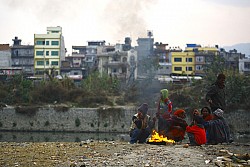 https://archive.nepalitimes.com/image.php?&width=250&image=/assets/uploads/gallery/12250-squatters-huddle-around-fire.jpg